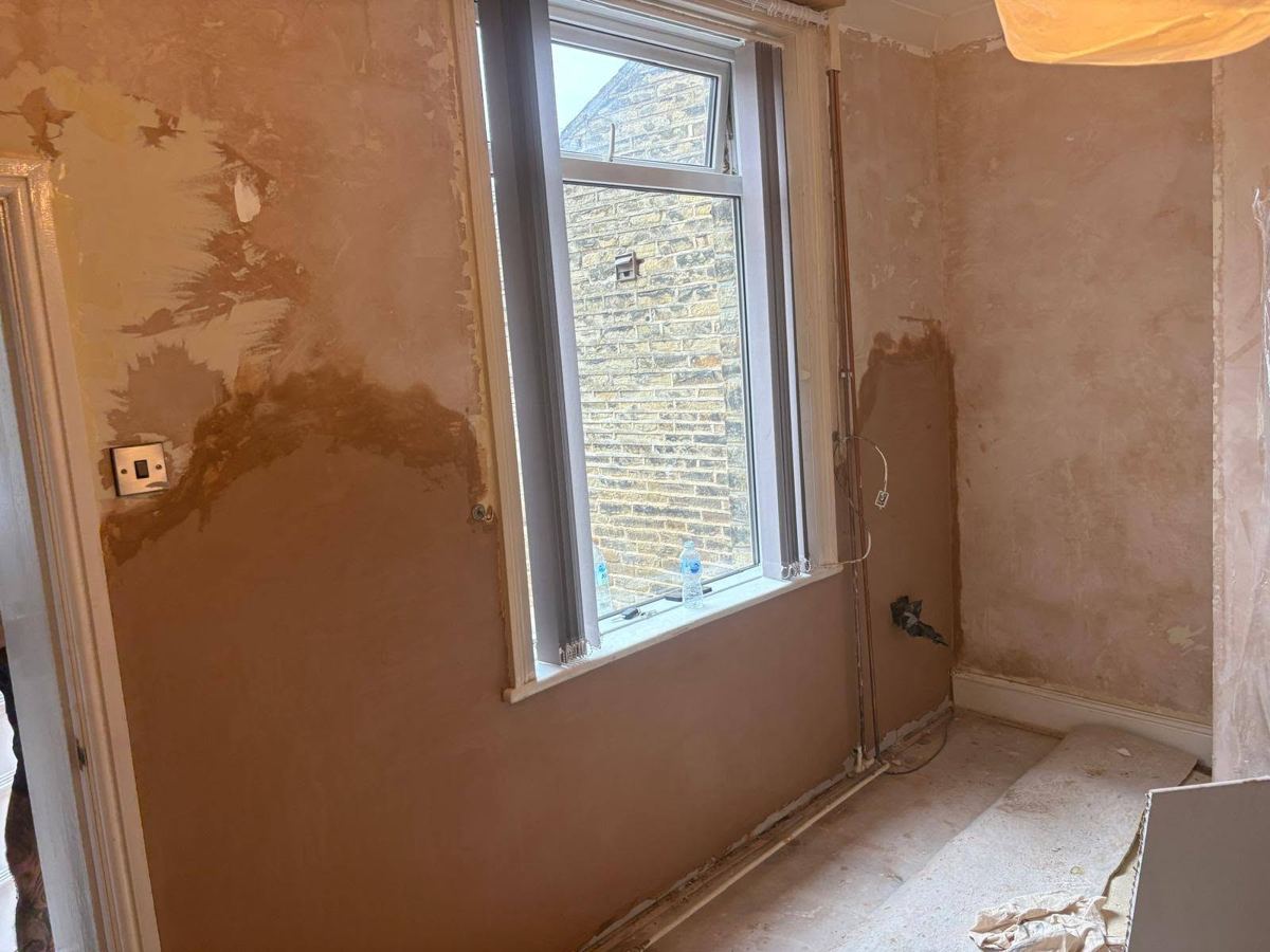 After: the same window wall replastered to a smooth finish