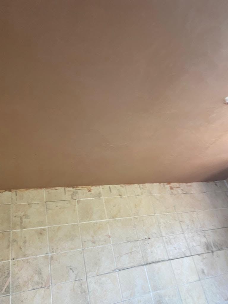 A bathroom ceiling boarded and skimmed smooth