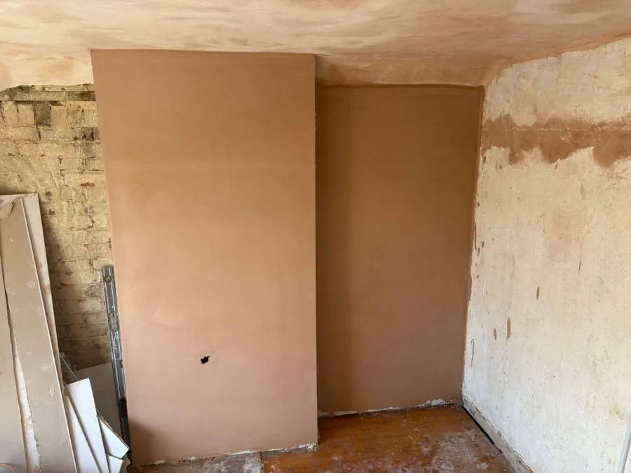 Freshly skimmed walls drying to an even finish during a full-home replaster