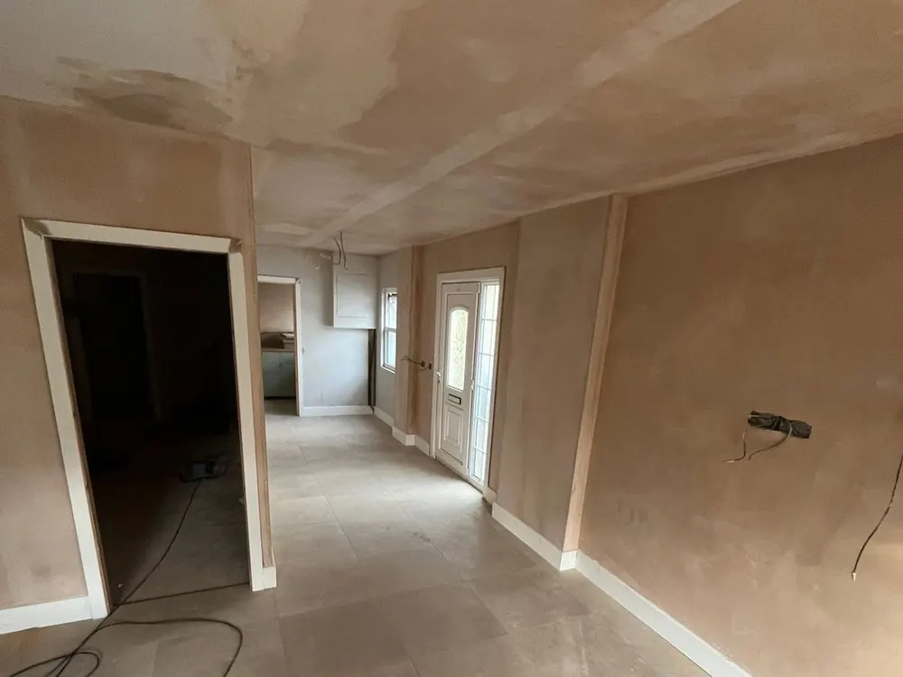 A ground floor freshly replastered on the walls and ceiling, ready for decorating