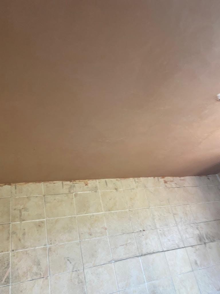 The same bathroom ceiling boarded and skimmed to a smooth finish