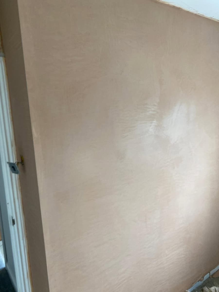 The same partition wall skimmed to a flat, smooth finish