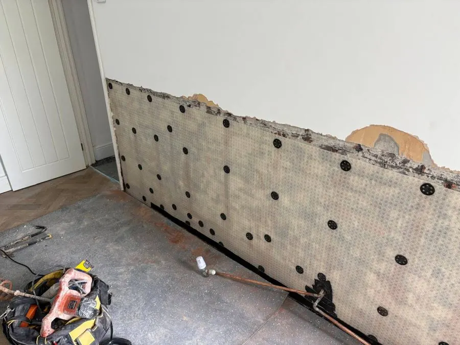 Specialist meshed membrane fixed to a treated wall during a rising damp treatment