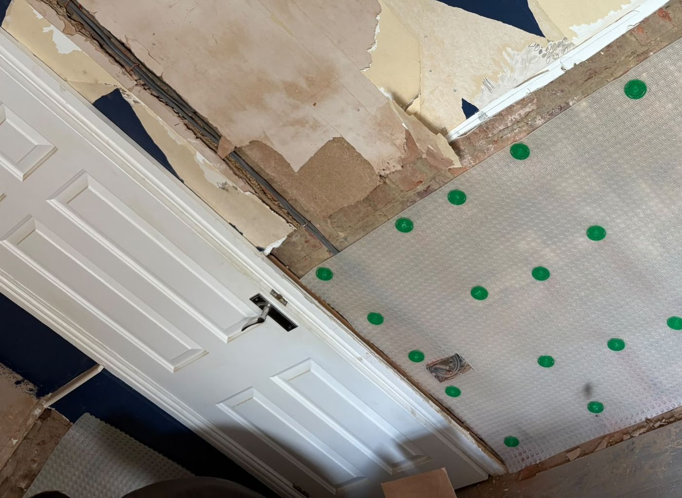 Damp proof membrane running through to a door reveal while the opposite wall is stripped back