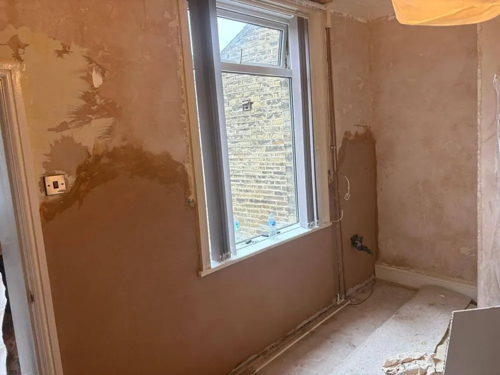 After: the same window wall replastered to a smooth finish
