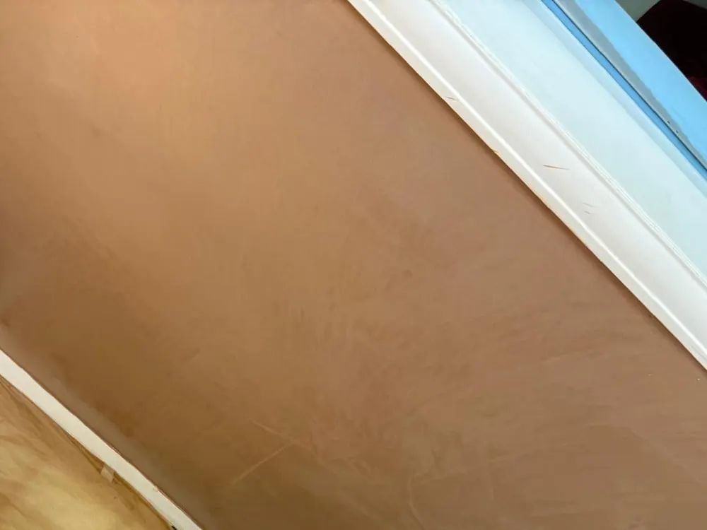 A stairwell wall freshly skimmed to a smooth finish over previous artex
